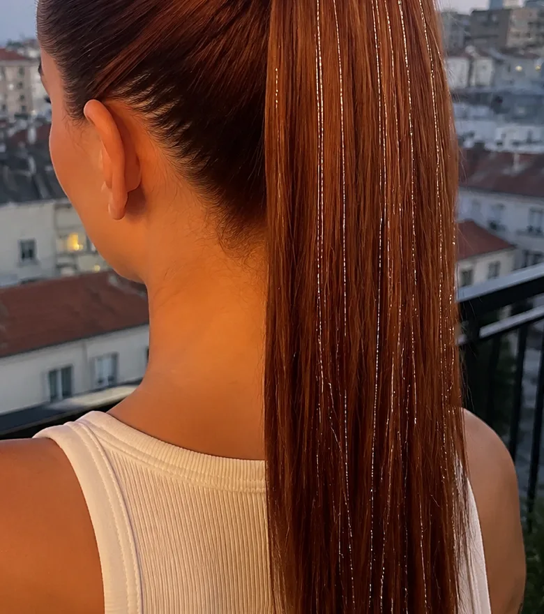 Copper ponytail with silver hair tinsel strands running down one side